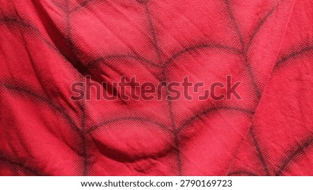 Red fabric texture with spider web pattern.