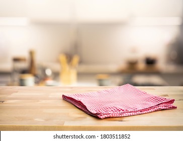 Red Fabric,cloth On Wood Table Top On Blur Kitchen Counter (room)background.For Montage Product Display Or Design Key Visual Layout.