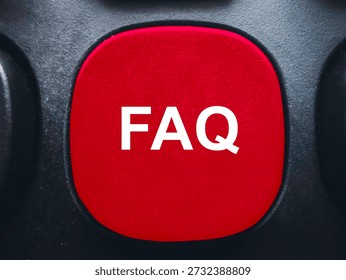 Red FAQ button on a black computer keyboard for help and frequently asked questions support