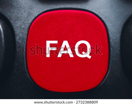 Red FAQ button on a black computer keyboard for help and frequently asked questions support