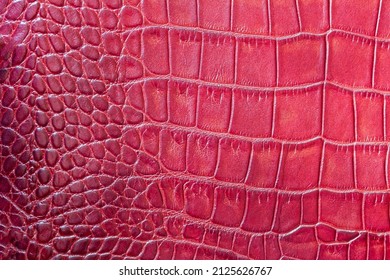 Red Fashion Scales Macro Exotic Background, Embossed Under The Skin Of A Reptile, Crocodile. Texture Genuine Leather Close-up, Trend. For Backdrop, Substrate, Composition Use. With Place For Your Text