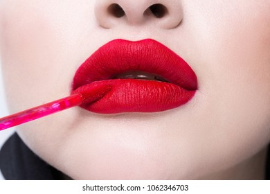red female seductive lips close-up. Brush for lips.