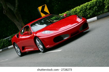 Red Ferrari F430 on the road in Singapore