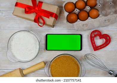 Red Festive Ingrediens For Cooking, Valentines Day Eggs, Rolling Pin And Whisk, Cutter Dish Shape Heart For Baking Cake Flat Lay, Chroma Key Smart Phone Copy Space.