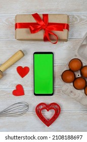 Red Festive Ingrediens For Cooking, Valentines Day Eggs, Rolling Pin And Whisk, Cutter Dish Shape Heart For Baking Cake Flat Lay, Chroma Key Smart Phone Copy Space.