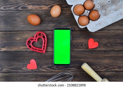 Red Festive Ingrediens For Cooking, Valentines Day Eggs, Rolling Pin And Whisk, Cutter Dish Shape Heart For Baking Cake Flat Lay, Chroma Key Smart Phone Copy Space.