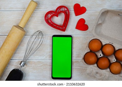 Red Festive Ingrediens For Cooking, Valentines Day Eggs, Rolling Pin And Whisk, Cutter Dish Shape Heart For Baking Cake Flat Lay, Chroma Key Smart Phone Copy Space.