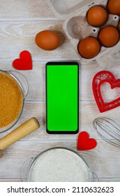 Red Festive Ingrediens For Cooking, Valentines Day Eggs, Rolling Pin And Whisk, Cutter Dish Shape Heart For Baking Cake Flat Lay, Chroma Key Smart Phone Copy Space.