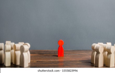 red figurine of a man stands aside from the crowd of people. Asociality, sociopathy. Rejected from society, lonely. Development of leadership and social qualities. Infected, fear and misunderstanding.