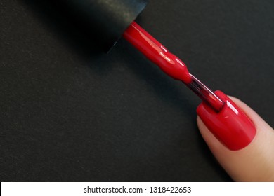 Red Finger nail point isolated black background with nail polish. Painting nail.