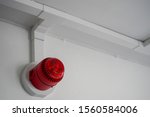Red fire alarm sounder on a wall 