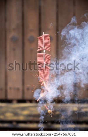 Red fire crackers string exploding with smokes background. Festival or celebration decoration equipment