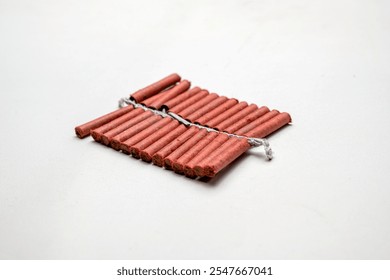 Red fire crackers string isolated over white background. Festival or celebration decoration equipment