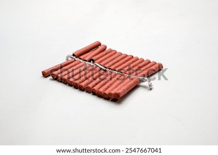 Red fire crackers string isolated over white background. Festival or celebration decoration equipment