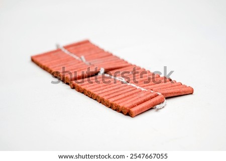 Red fire crackers string isolated over white background. Festival or celebration decoration equipment