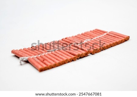 Red fire crackers string isolated over white background. Festival or celebration decoration equipment