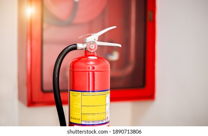 The Red Fire Extinguisher Is Ready For Use In Case Of An Indoor Fire Emergency.