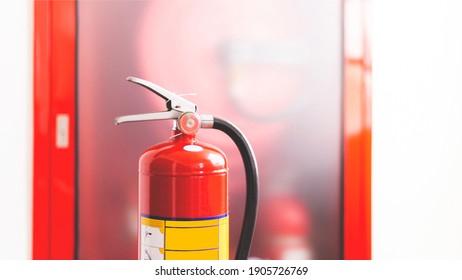 The Red Fire Extinguisher Is Ready For Use In Case Of An Indoor Fire Emergency.