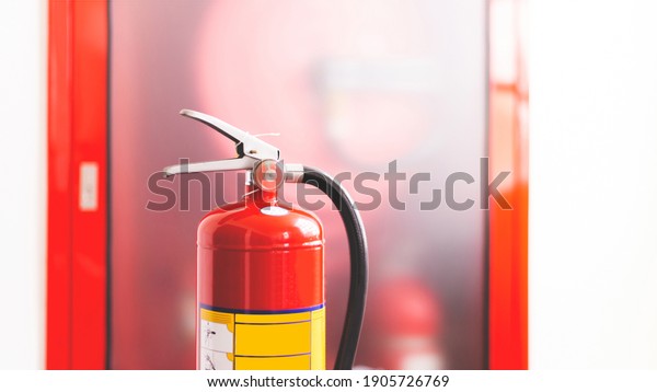 The red fire extinguisher is ready for use in\
case of an indoor fire\
emergency.