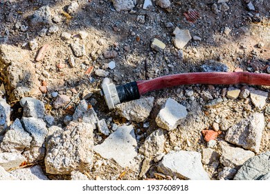 Red Fire Hose With Fitting On A Ground