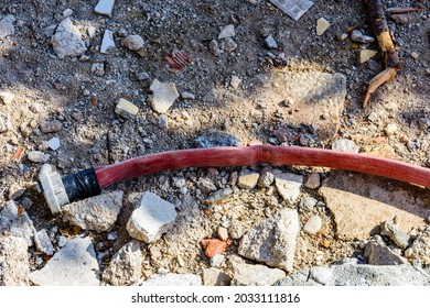 Red Fire Hose With Fitting On A Ground