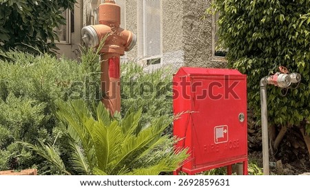 Red Fire Hydrant Beside Utility Box on Urban Street