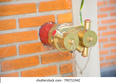 Red fire hydrant in the brick wall