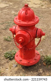 Red Fire Hydrant in Dirt and Weeds