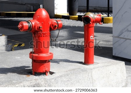 Red fire hydrant in front of a building