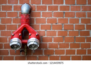 Red fire hydrant on brick wall background