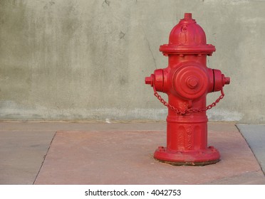 Red fire hydrant on a sidewalk.