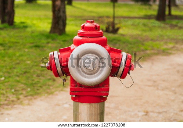 Red fire hydrant on the street in Europe.\
Red overground fire hydrant in the city\
.