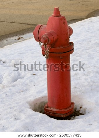 A red fire hydrant in the snow