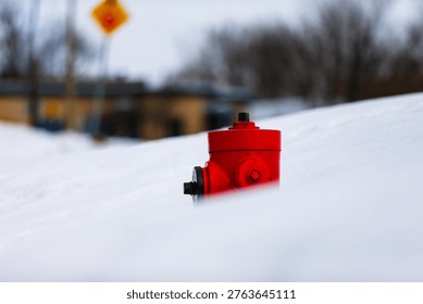 Red fire hydrant in the snow in winter, Quebec, Canada.