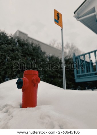 Red fire hydrant in the snow in winter, Quebec, Canada.