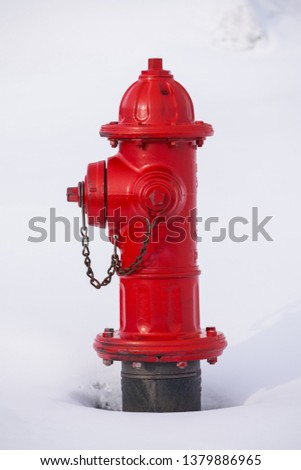 Red fire hydrant in white snow