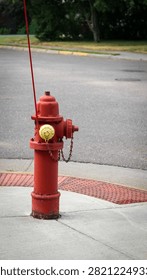 Red fire hydrant with yellow cap on sidewalk. Infrastructure and safety design element with banner or background.