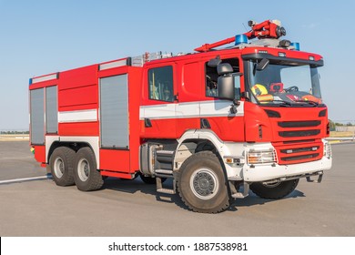 Red Fire Truck On The Airport Runway With Equipment For Firefighting Operations