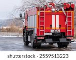 Red fire truck parked on the outskirts of the city. Special equipment for fighting fire.