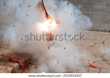 Red firecrackers exploding in the street for the chinese new year celebration day.Chinese New Year festival firecrackers with smoke.