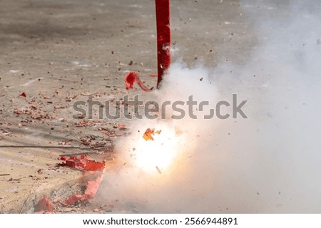 Red firecrackers exploding in the street for the chinese new year celebration day.Chinese New Year festival firecrackers with smoke.