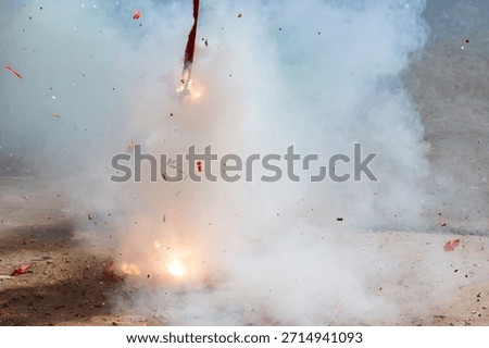 Red firecrackers exploding in the street for the chinese new year celebration day.Chinese New Year festival firecrackers with smoke.