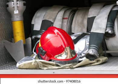 Red firefighter helmet and hose
