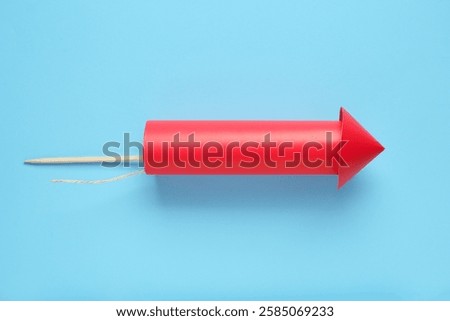 Red firework rocket on blue background