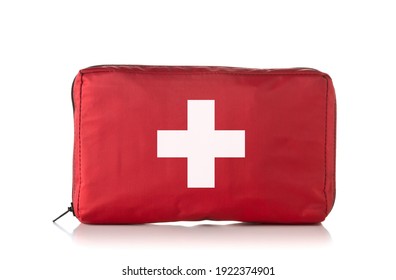 Red first aid medical kit bag standing over white background
