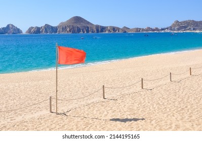 Red Flag In The Beach Of Los Cabos, Mexico