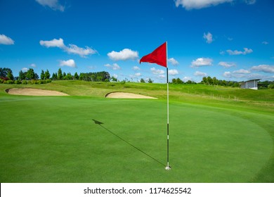 Red Flag And The Hole At Golf Club