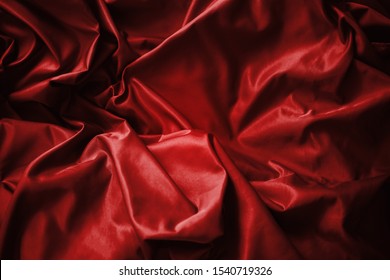 Red Flag Law And Gun Control In The United States Concept. Silk Fabric Background. Image Shows Detailed Flag Wrinkled, Shadows And Studio Lights