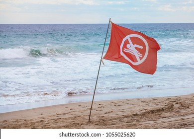 Red Flag On The Beach.