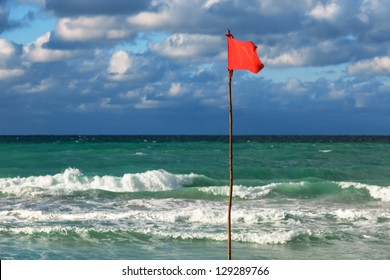 Red Flag On The Beach During A Storm